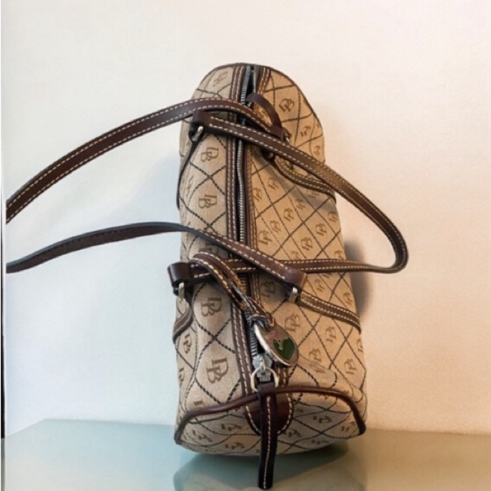Dooney and Bourke barrel bag. Older design, black and light brown with straps.